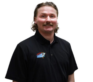 Project Manager Justin, in a black Excel Roofing uniform, stands confidently with the company logo visible, representing Excel Roofing's commitment to superior roofing services across the Front Range